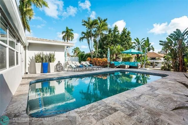 a view of a backyard with sitting area