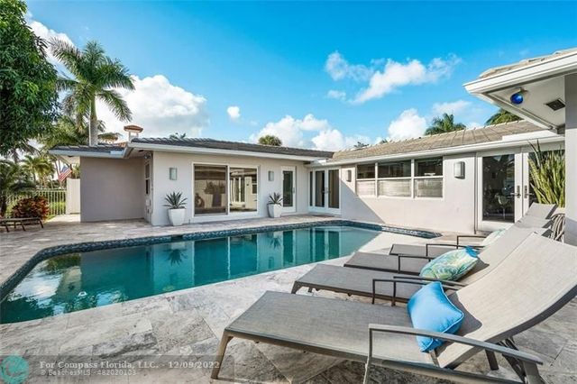 a view of a lake with couches chairs