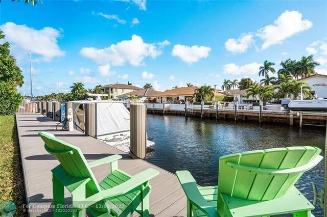 an aerial view of a house with a garden and lake view