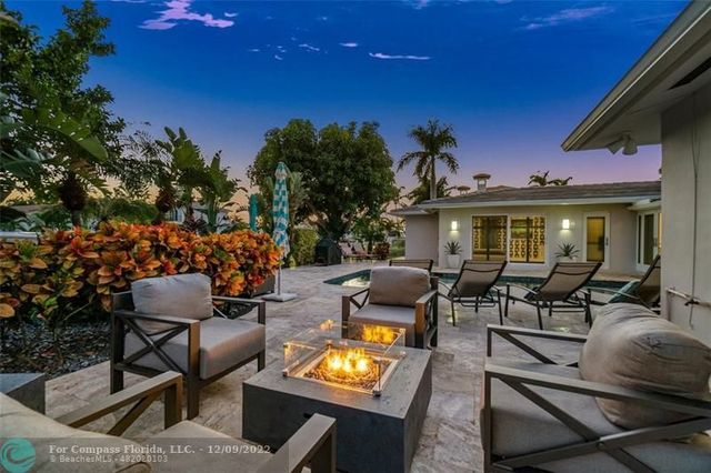 a view of an outdoor sitting area with furniture and tv