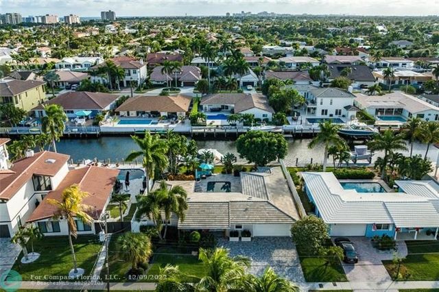 a view of a house with a yard and potted plants