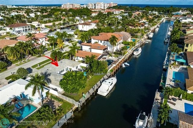 a view of a house with a potted plant and a yard