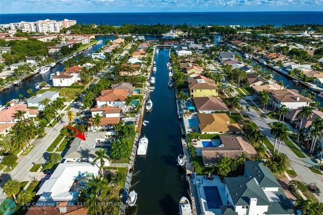 a view of a house with pool and sitting area