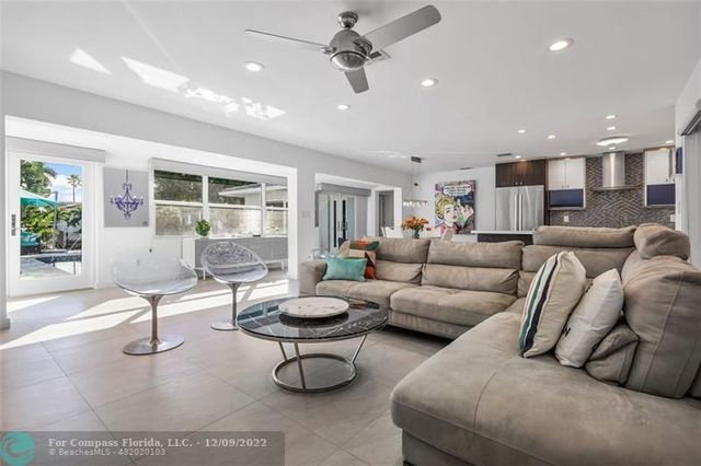 a living room with furniture and floor to ceiling window
