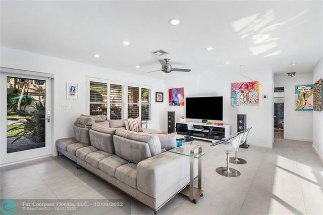 a living room with lots of furniture and kitchen view