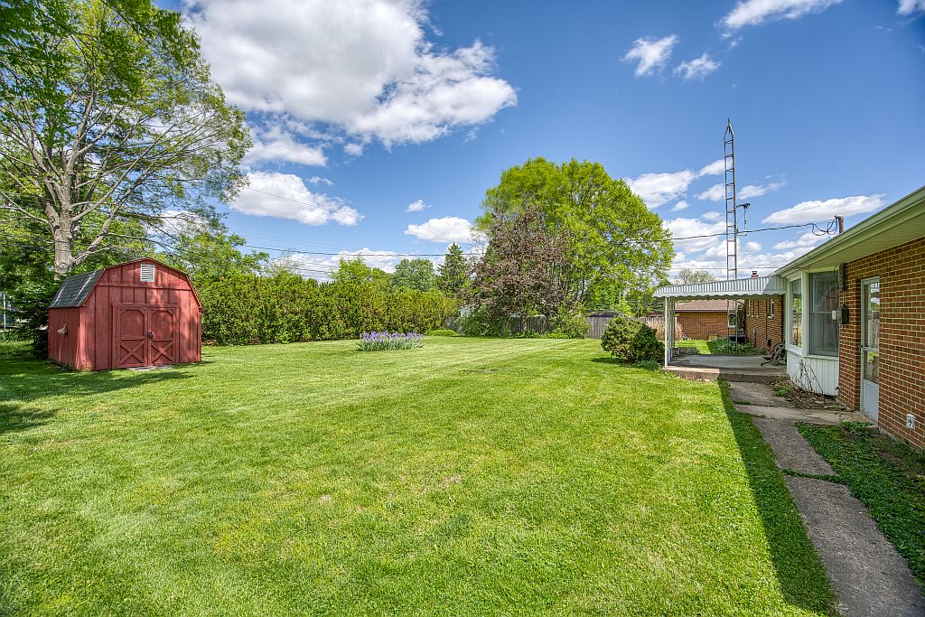 324 Beckenham Road Englewood, OH 45322 - Photo 21 of 26 This spacious yard offers ample green space and a charming storage shed.