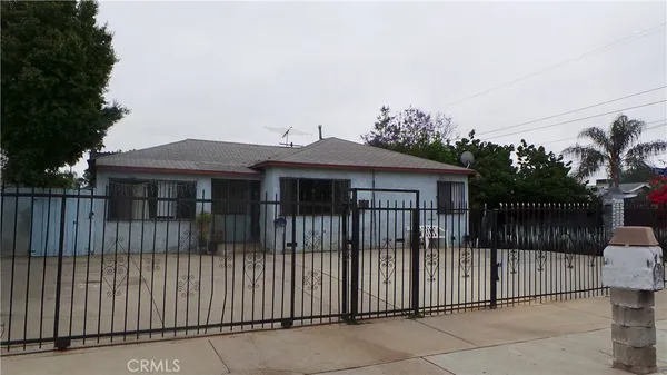 a view of a house with iron fence