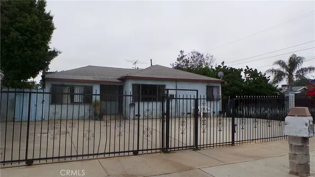 a view of a house with iron fence