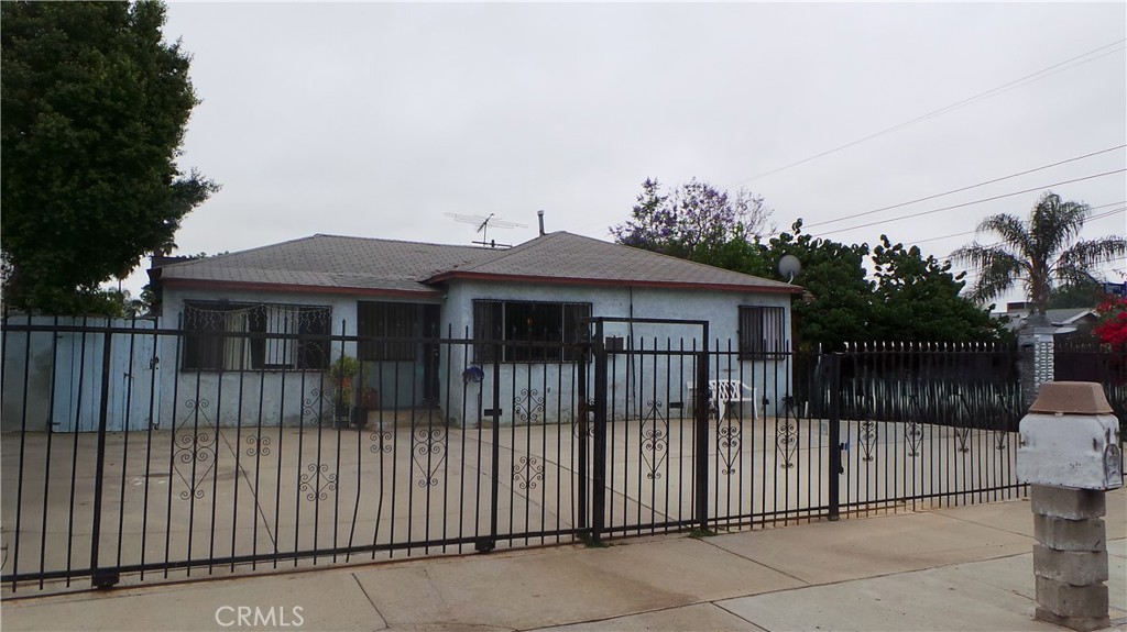 a view of a house with iron fence