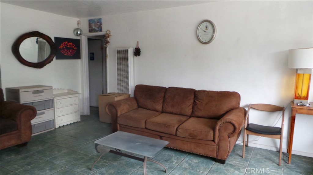 13912 Daventry Street Pacoima, CA 91331 - Photo 3 of 10 a living room with furniture a rug and a window