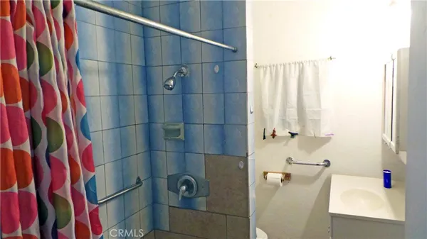 a bathroom with a shower and a sink