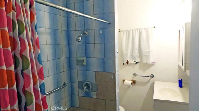 a bathroom with a shower and a sink