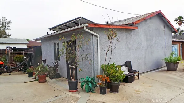 a view of a house with potted plants