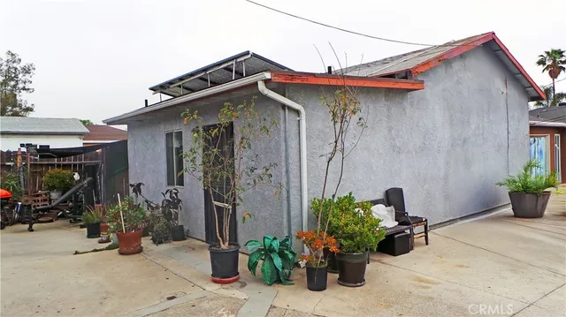 a view of a house with potted plants