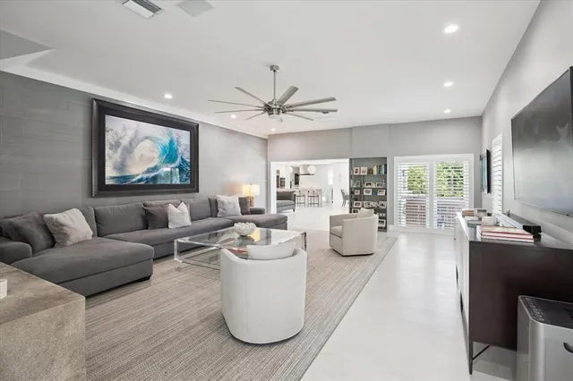 a living room with furniture a large window and a chandelier