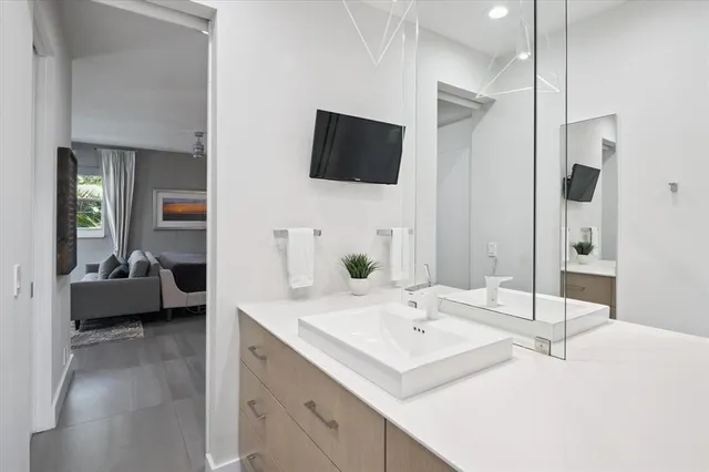 a en suite bathroom with a sink and mirror