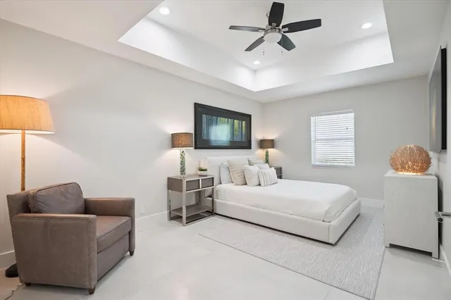 a bedroom with a bed couch and window