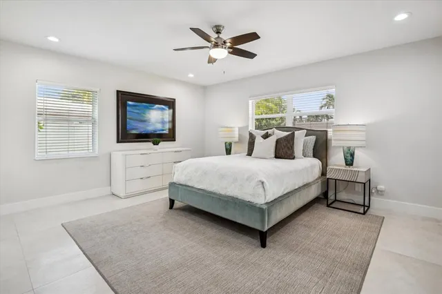 a bedroom with a large bed a flat screen tv and couches