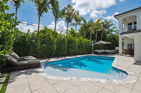 a backyard of a house with barbeque oven table and chairs