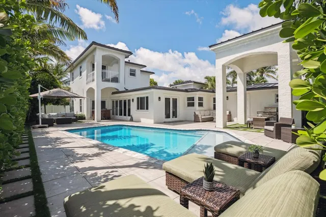 a view of a house with swimming pool and porch