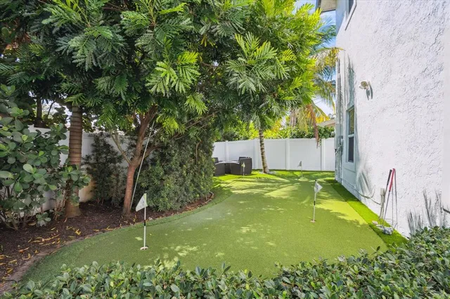 a view of a backyard with plants and a patio