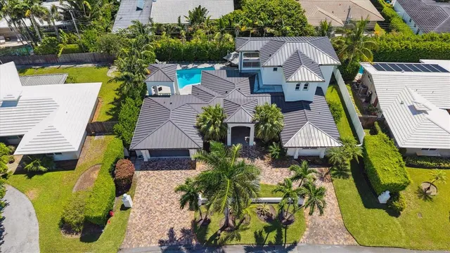 an aerial view of a house with a yard and garden