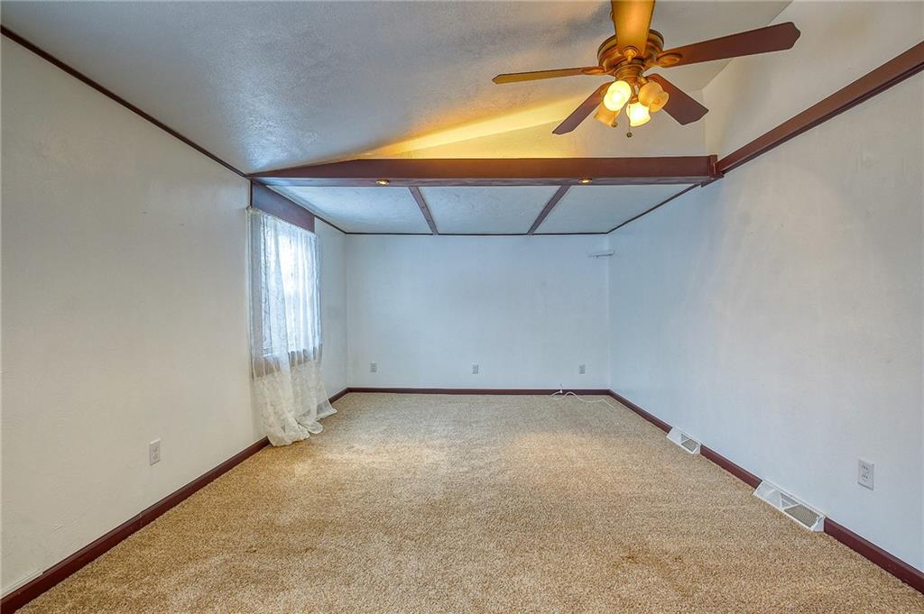 224 Roberts Road Plum, PA 15239 - Photo 5 of 25 an empty room with a chandelier fan and wooden floor