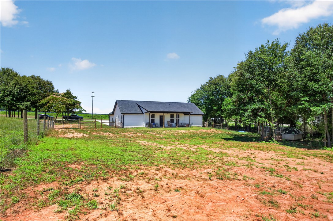 106 Bolt Road Townville, SC 29689 - Photo 28 of 33 A tranquil rural setting with a neatly kept residence nestled among mature trees and an expansive yard.