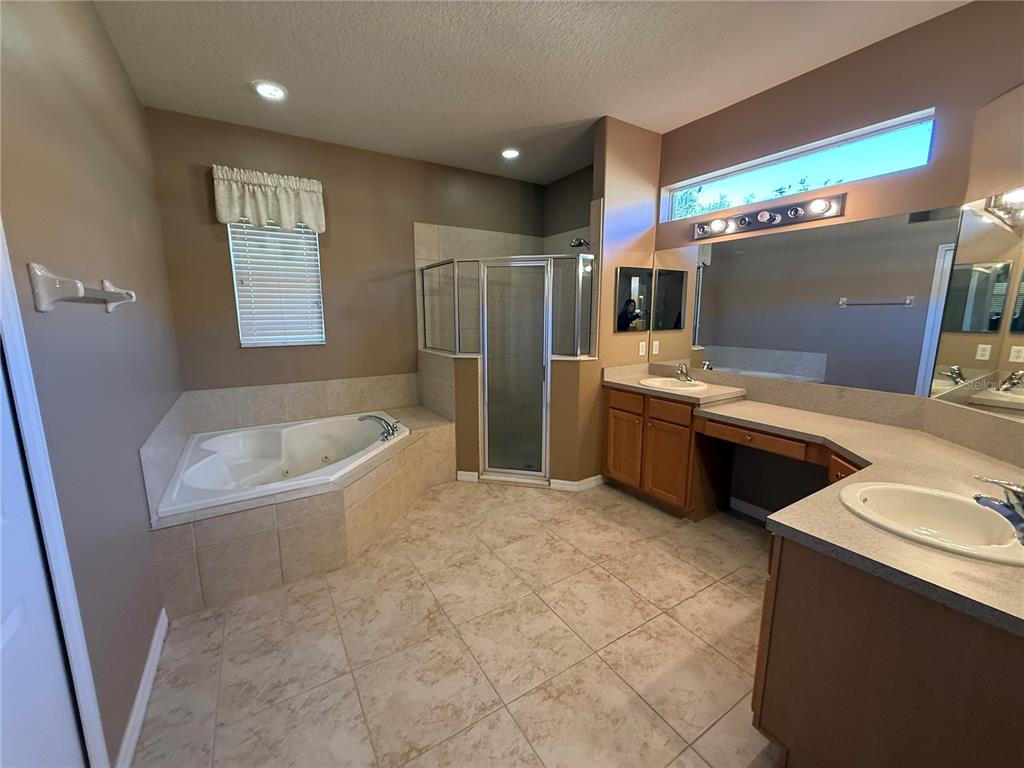 3231 Pawleys Loop North St. Cloud, FL 34769 - Photo 16 of 34 a bathroom with a sink toilet and shower