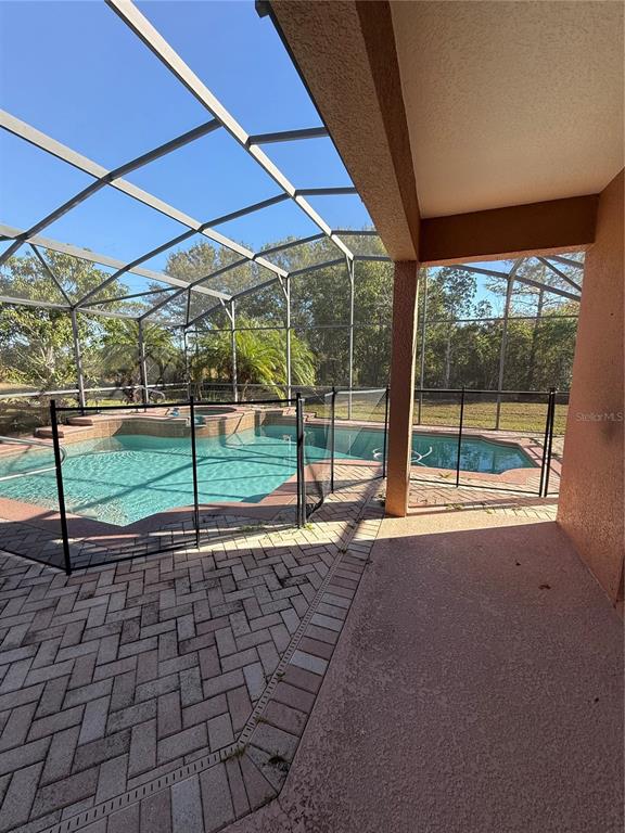 3231 Pawleys Loop North St. Cloud, FL 34769 - Photo 30 of 34 a view of a backyard with table and chairs under an umbrella