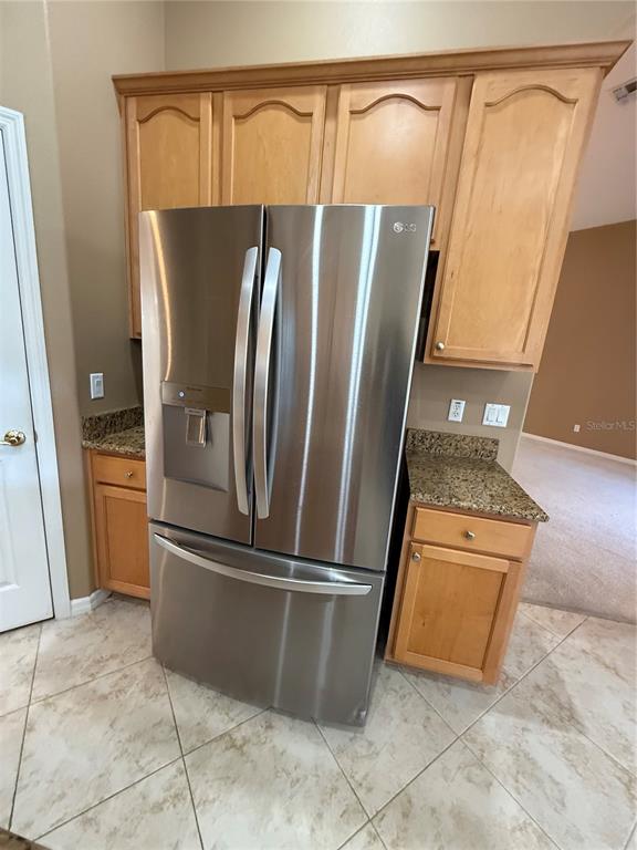3231 Pawleys Loop North St. Cloud, FL 34769 - Photo 10 of 34 a view of a refrigerator in kitchen and an empty room