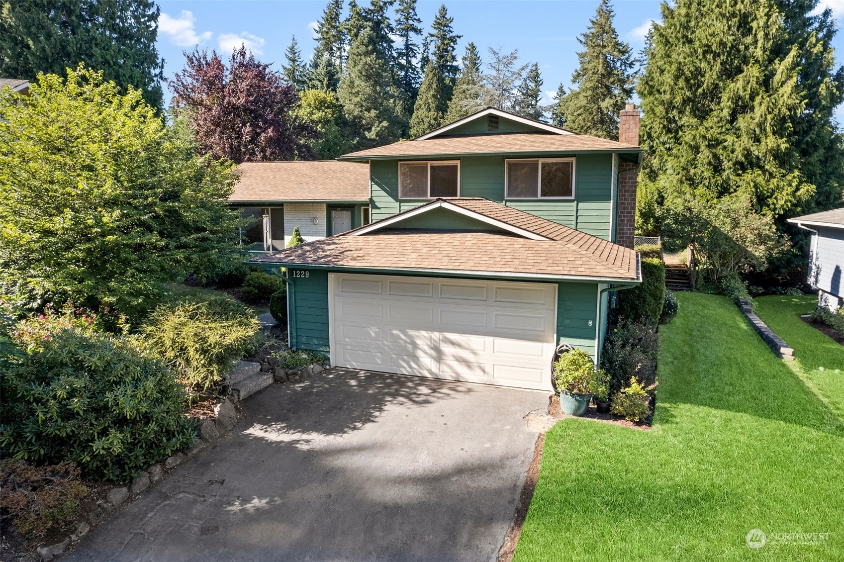 1229 206th Street Southeast Bothell, WA 98012 - Photo 1 of 40 a front view of a house with a yard