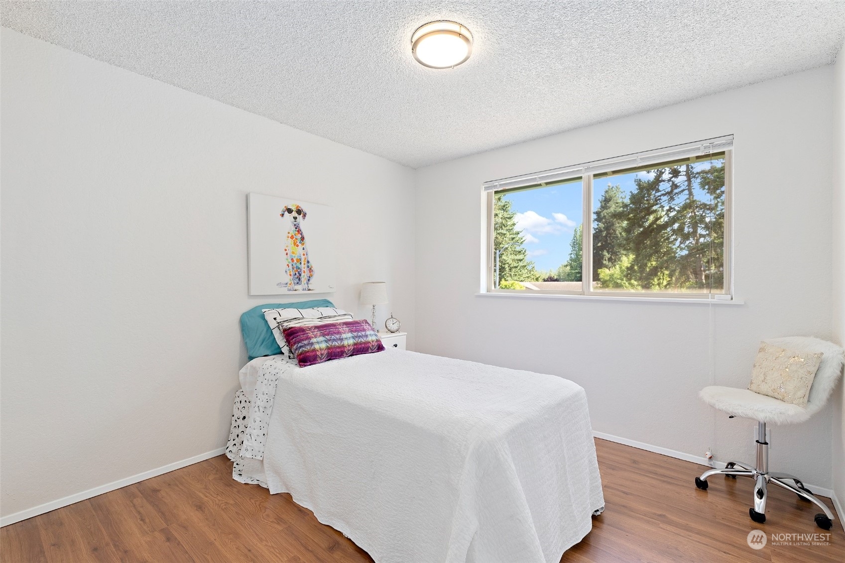 1229 206th Street Southeast Bothell, WA 98012 - Photo 17 of 40 a bedroom with a bed and a table in it