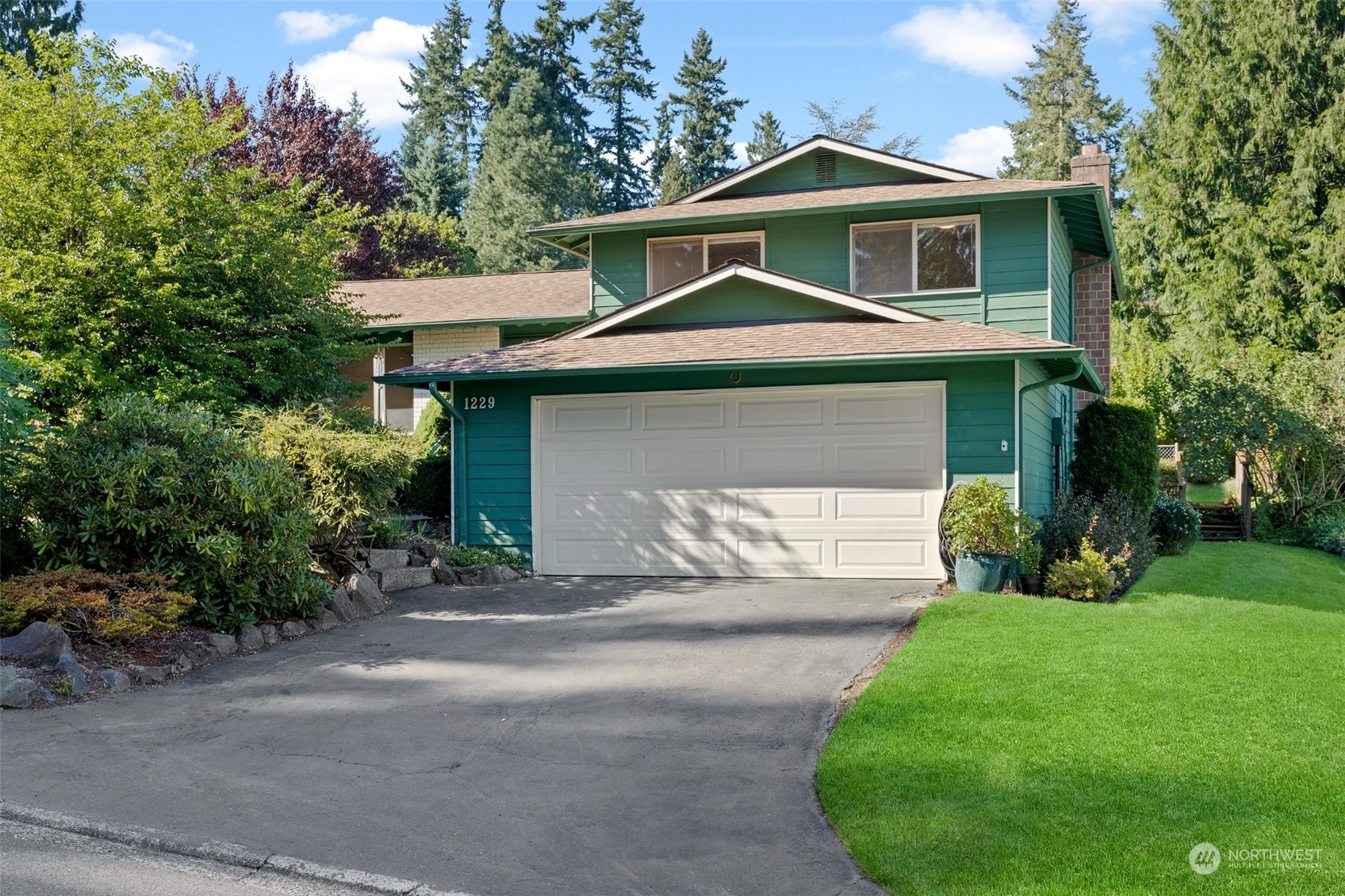 1229 206th Street Southeast Bothell, WA 98012 - Photo 2 of 40 a front view of a house with a yard