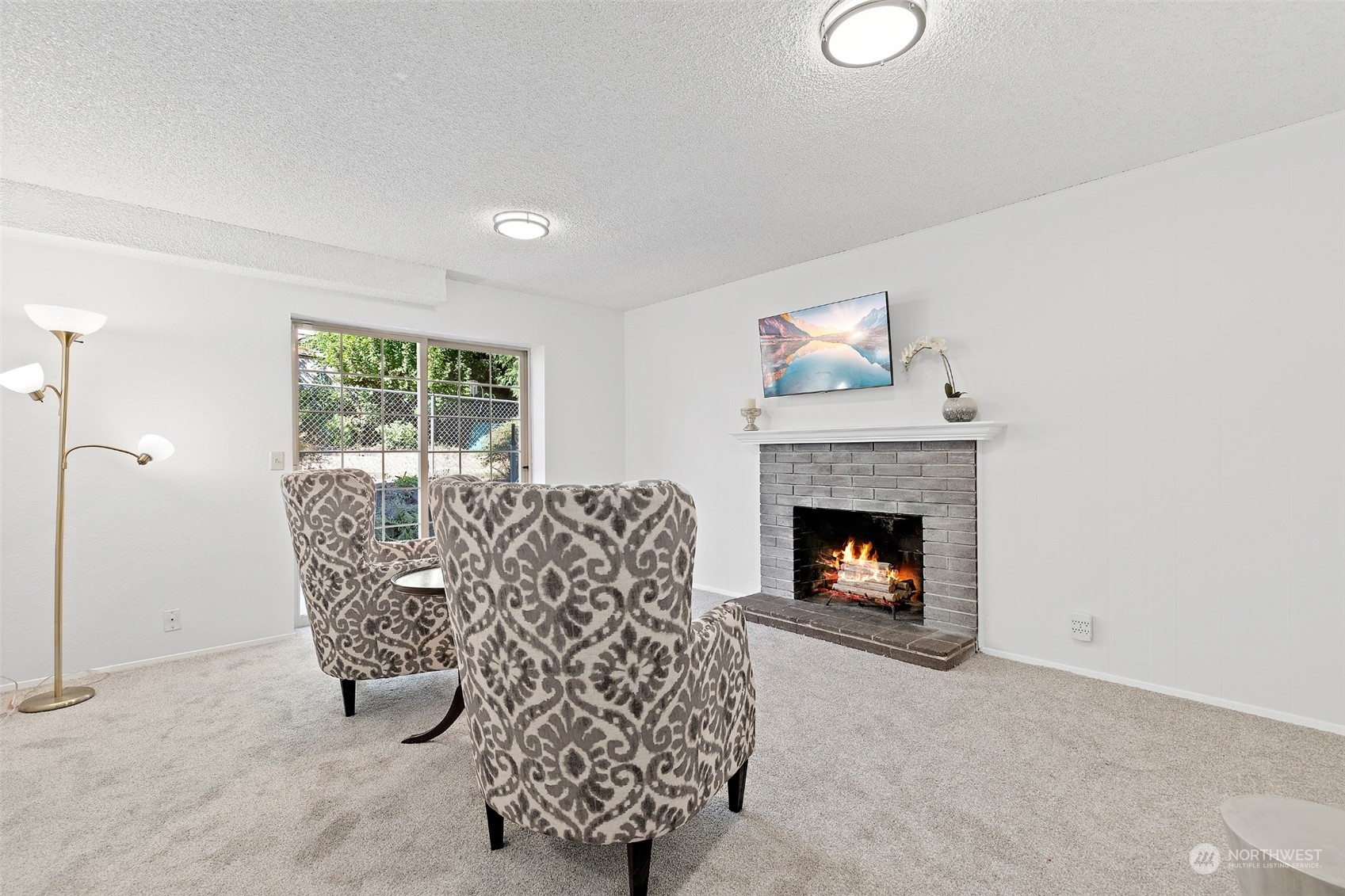 1229 206th Street Southeast Bothell, WA 98012 - Photo 24 of 40 a living room with furniture a fireplace and a floor to ceiling window