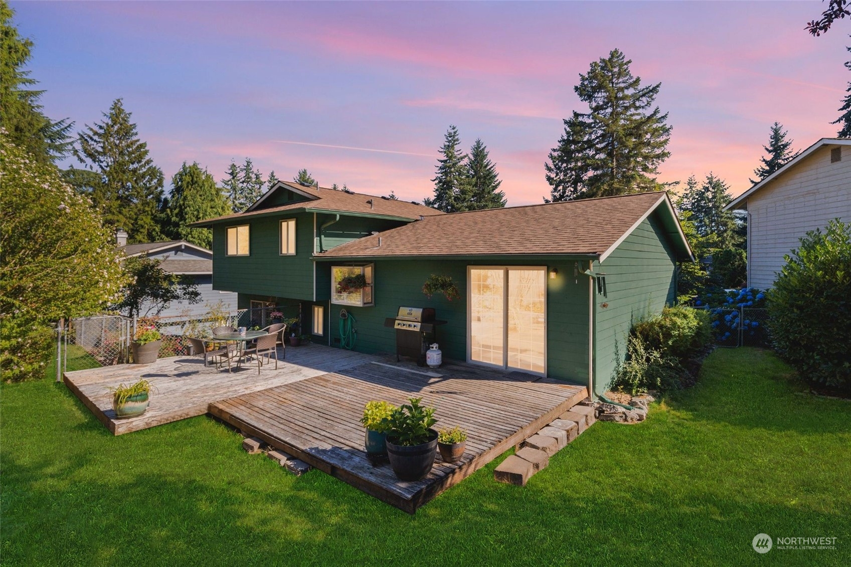 1229 206th Street Southeast Bothell, WA 98012 - Photo 26 of 40 a view of a house with patio and garden