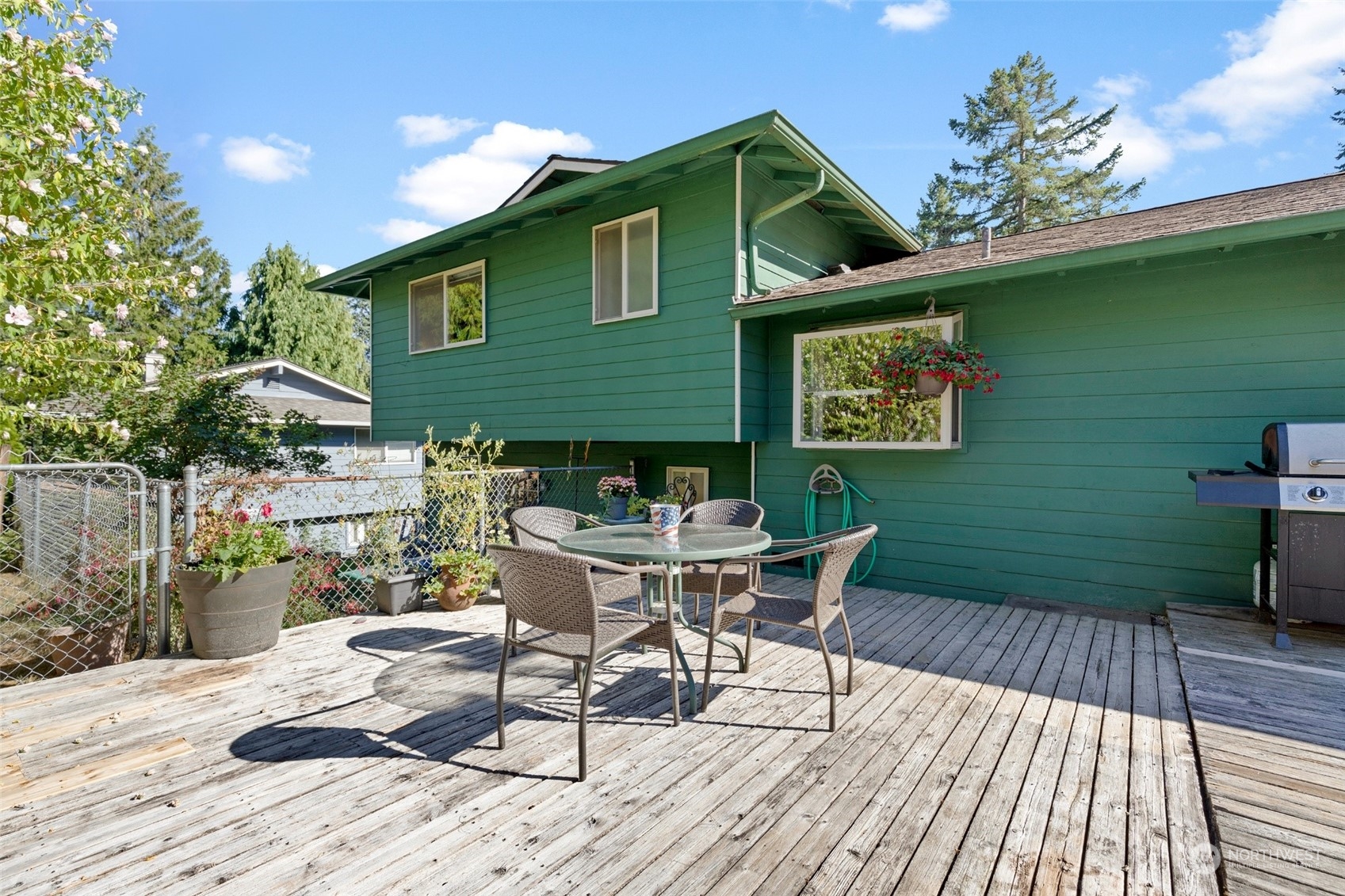 1229 206th Street Southeast Bothell, WA 98012 - Photo 27 of 40 a backyard of a house with table and chairs