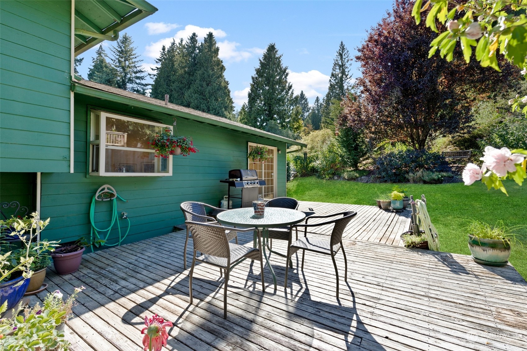 1229 206th Street Southeast Bothell, WA 98012 - Photo 28 of 40 a view of backyard with outdoor seating a patio and plants