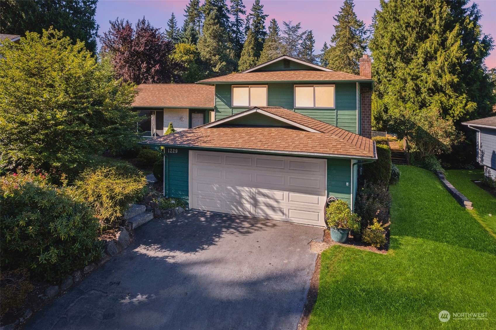 1229 206th Street Southeast Bothell, WA 98012 - Photo 34 of 40 a front view of a house with a yard and garage