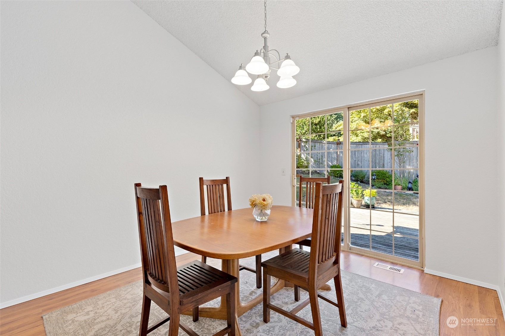 1229 206th Street Southeast Bothell, WA 98012 - Photo 8 of 40 a view of a dining room with furniture a chandelier and wooden floor
