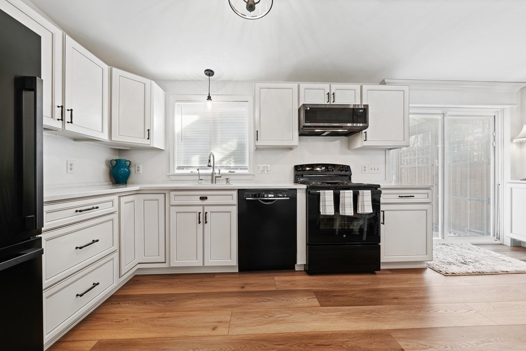 26-28 South Road Londonderry, NH 03053 - Photo 15 of 27 a kitchen with stainless steel appliances granite countertop a stove sink and refrigerator