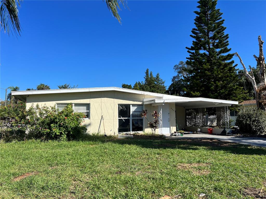 5323 Carlton Road New Port Richey, FL 34652 - Photo 2 of 11 a front view of a house with garden