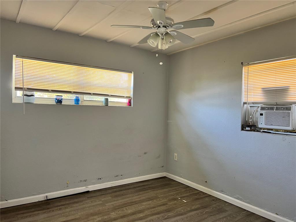 5323 Carlton Road New Port Richey, FL 34652 - Photo 8 of 11 an empty room with wooden floor and windows
