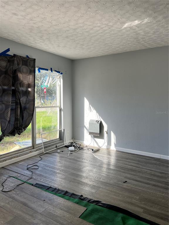 5323 Carlton Road New Port Richey, FL 34652 - Photo 10 of 11 a view of an empty room with wooden floor and a window