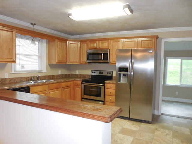 2371 Rutrough Road Southeast Roanoke, VA 24014 - Photo 13 of 34 a kitchen with granite countertop a refrigerator and a sink