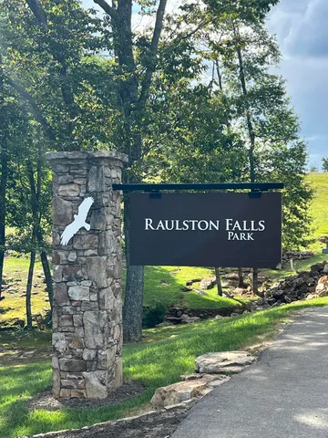 a view of a park that has large trees