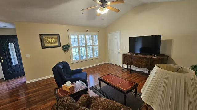 a living room with furniture and a flat screen tv