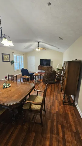 a very nice looking dining room with furniture and wooden floor