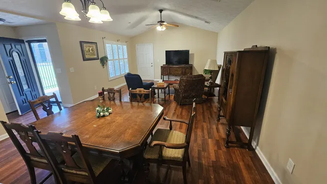 a view of a dining room with furniture and wooden floor