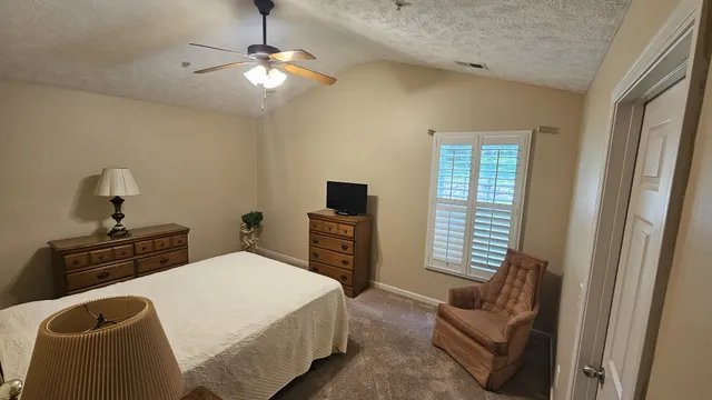 a bedroom with a bed and a couch